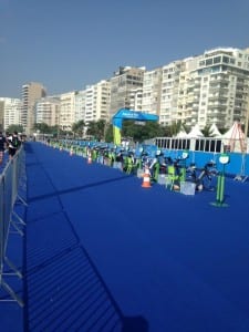 The stunning blue carpet of the transition area and the glass-front athlete lounge overlooking the swim and finish line