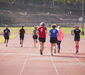 athletes running track coaching session