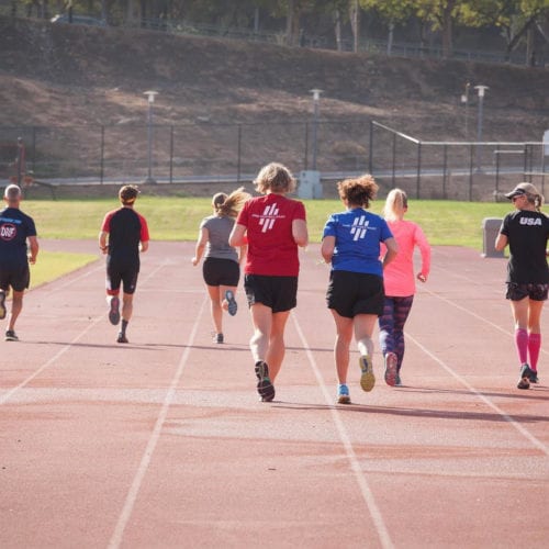 athletes running track coaching session